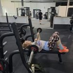Author performing a bench press exercise in the gym