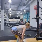 Author doing a deadlift exercise in the gym