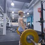 author doing a deadlift for spine strength
